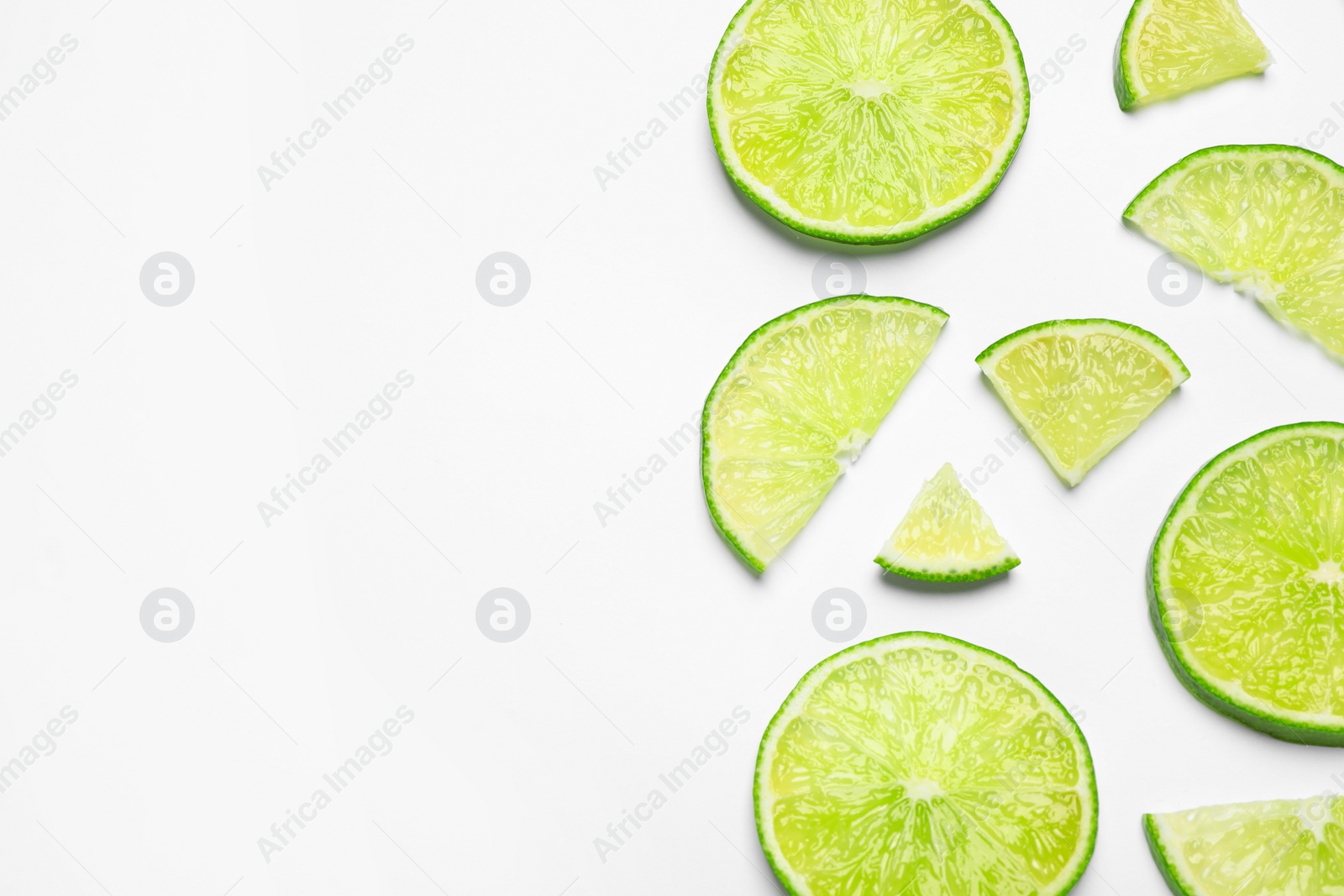 Photo of Juicy fresh lime slices on white background, top view