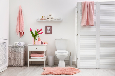 Photo of Interior of stylish bathroom with toilet bowl and decor elements