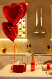 Photo of Romantic atmosphere. Cosy kitchen with table decorated for Valentine day