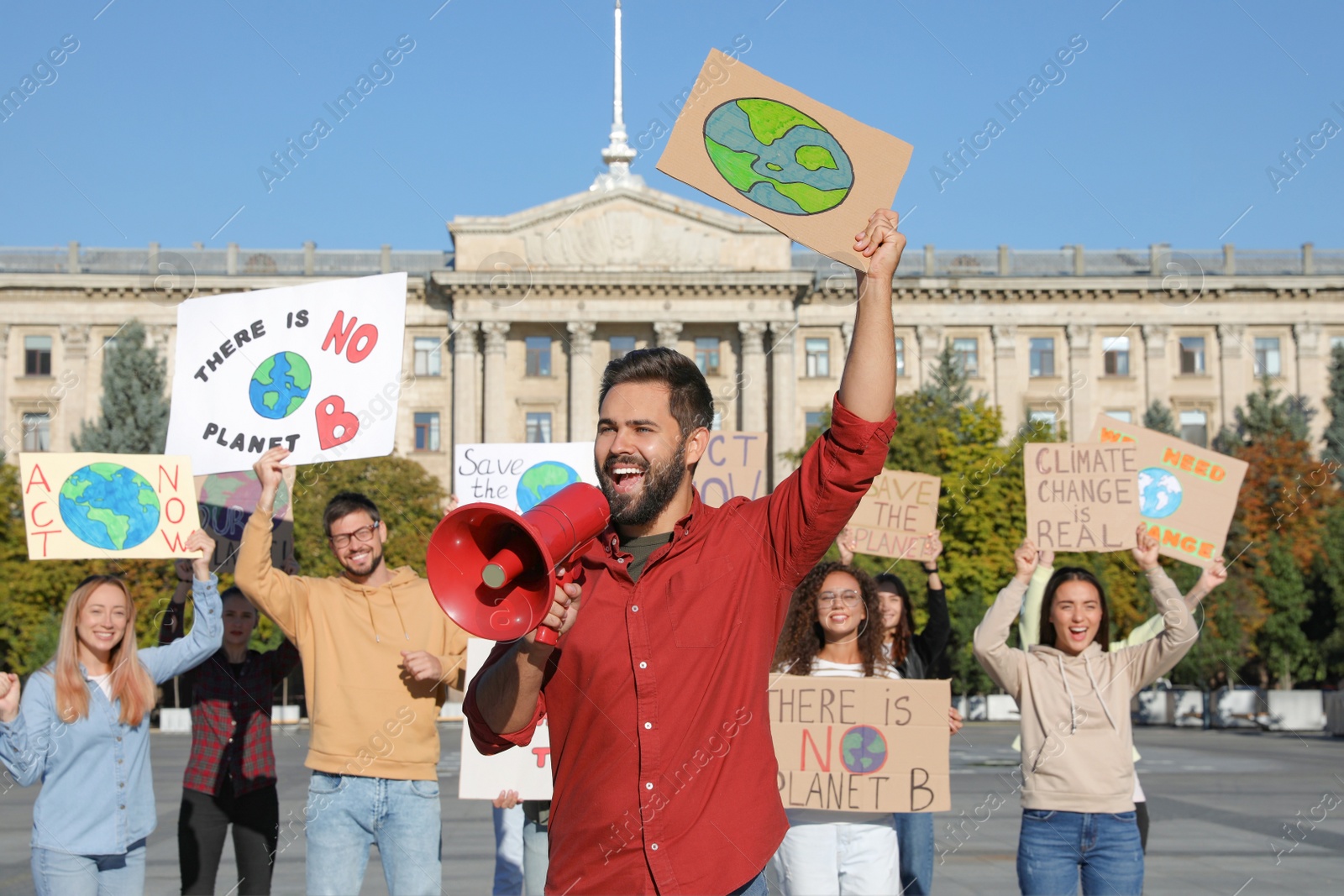 Photo of Group of people with posters protesting against climate change on city street