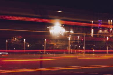 Photo of Road with light trails in city, motion blur effect. Night life