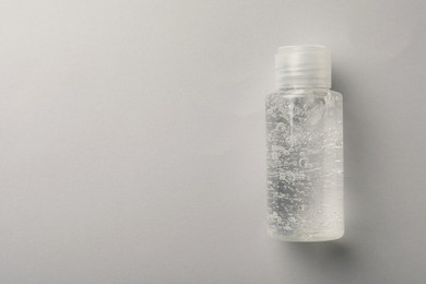 Photo of Bottle of cosmetic gel on white background, top view. Space for text