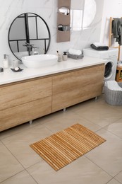 Wooden mat on floor in bathroom. Interior design