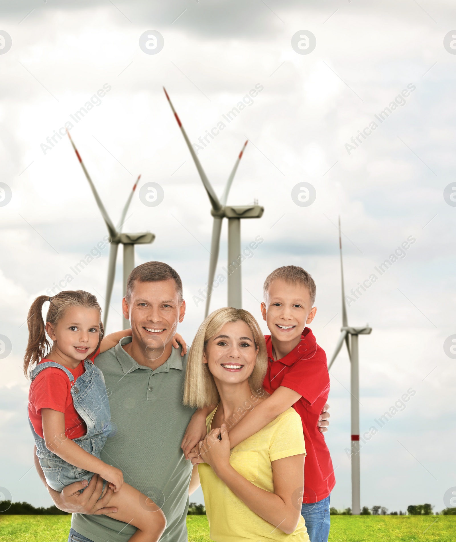 Image of Happy family with children and view of wind energy turbines