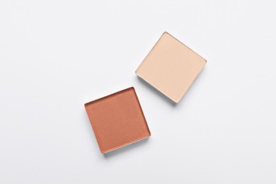 Beautiful eye shadow refill pans on white background, flat lay