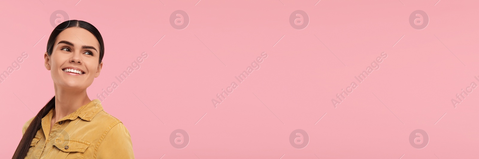 Image of Woman with clean teeth smiling on pink background, space for text. Banner design