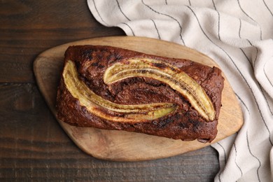 Photo of Delicious banana bread on wooden table, top view