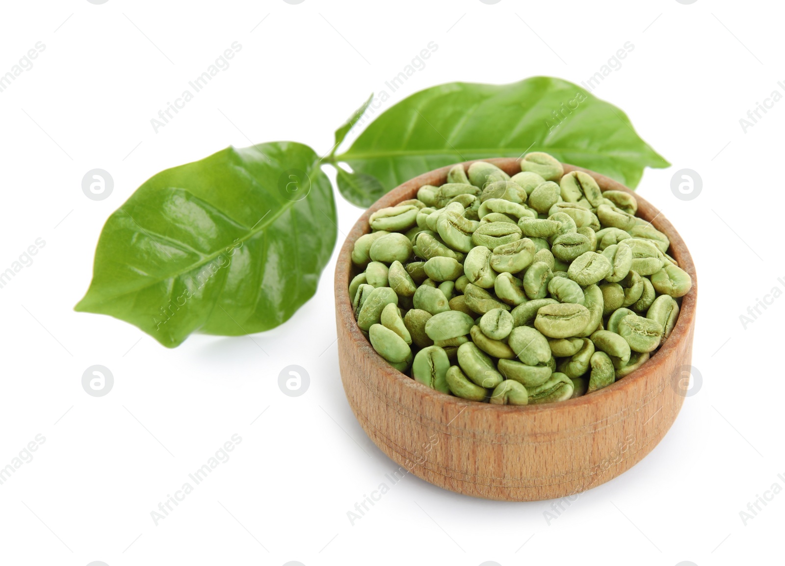 Photo of Wooden bowl with green coffee beans and fresh leaves on white background