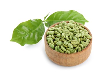 Photo of Wooden bowl with green coffee beans and fresh leaves on white background