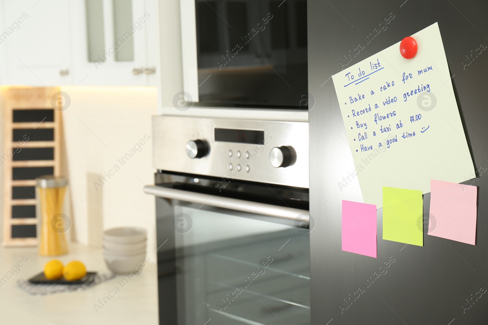 Photo of To do list and sticky notes on fridge in kitchen. Space for text