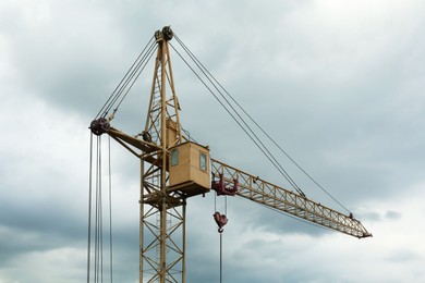 Construction site with tower crane under beautiful cloudy sky