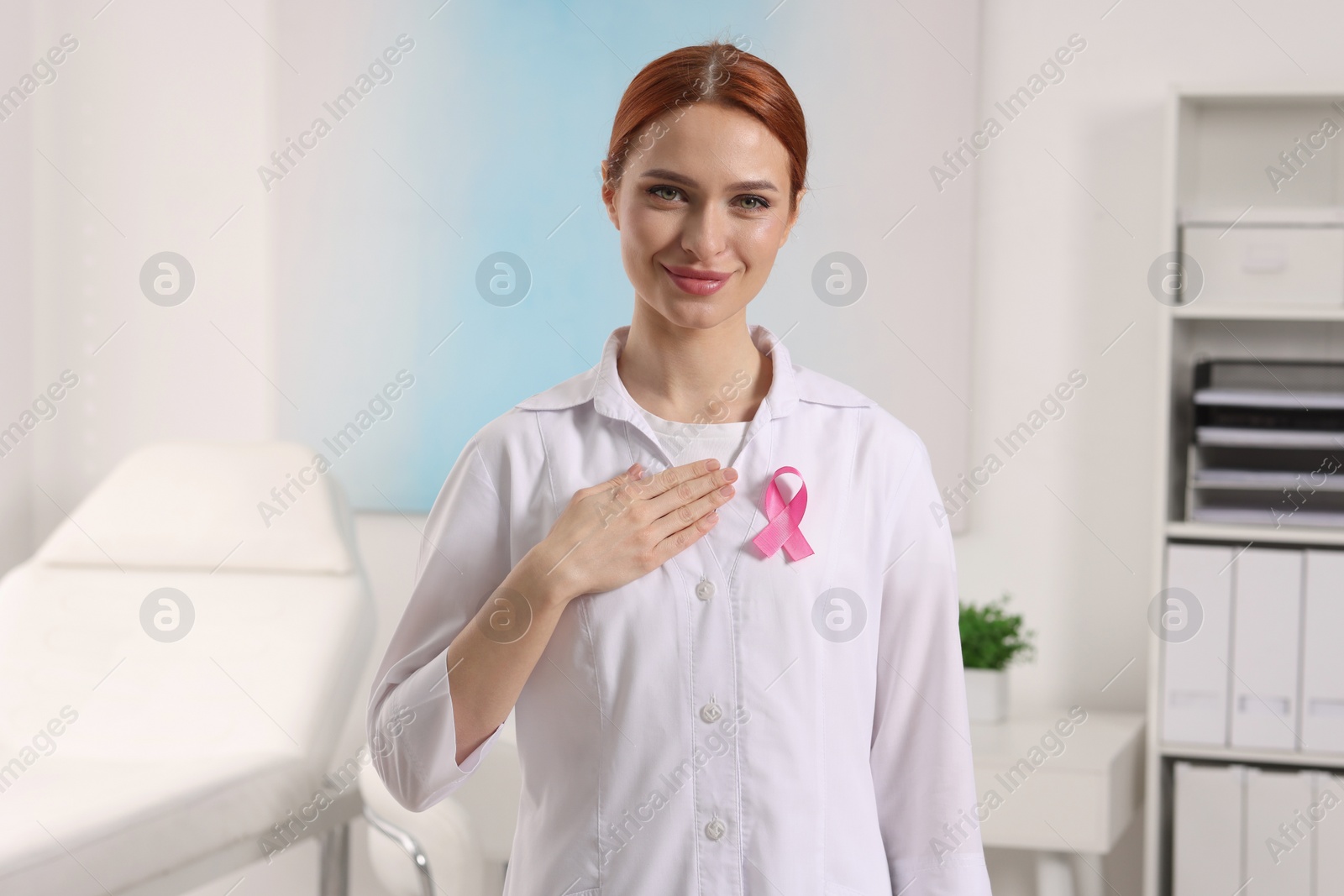 Photo of Mammologist with pink ribbon in hospital. Breast cancer awareness