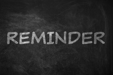 Image of Word REMINDER written on blackboard. Don't forget 