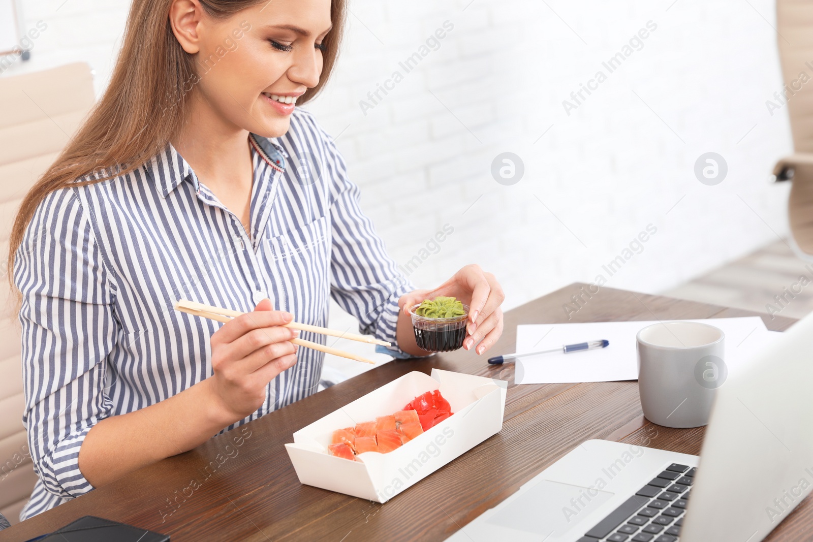 Photo of Office employee having lunch at workplace. Food delivery