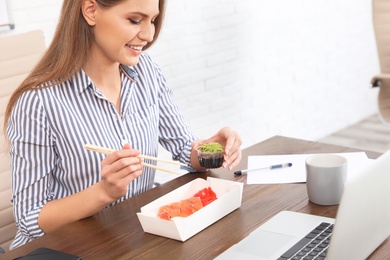 Office employee having lunch at workplace. Food delivery