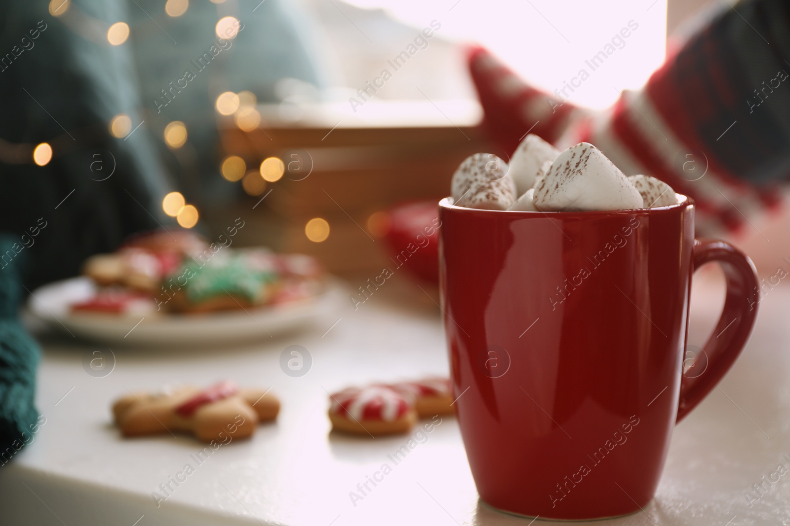 Photo of Cup of delicious hot cocoa with marshmallows on white table. Winter drink