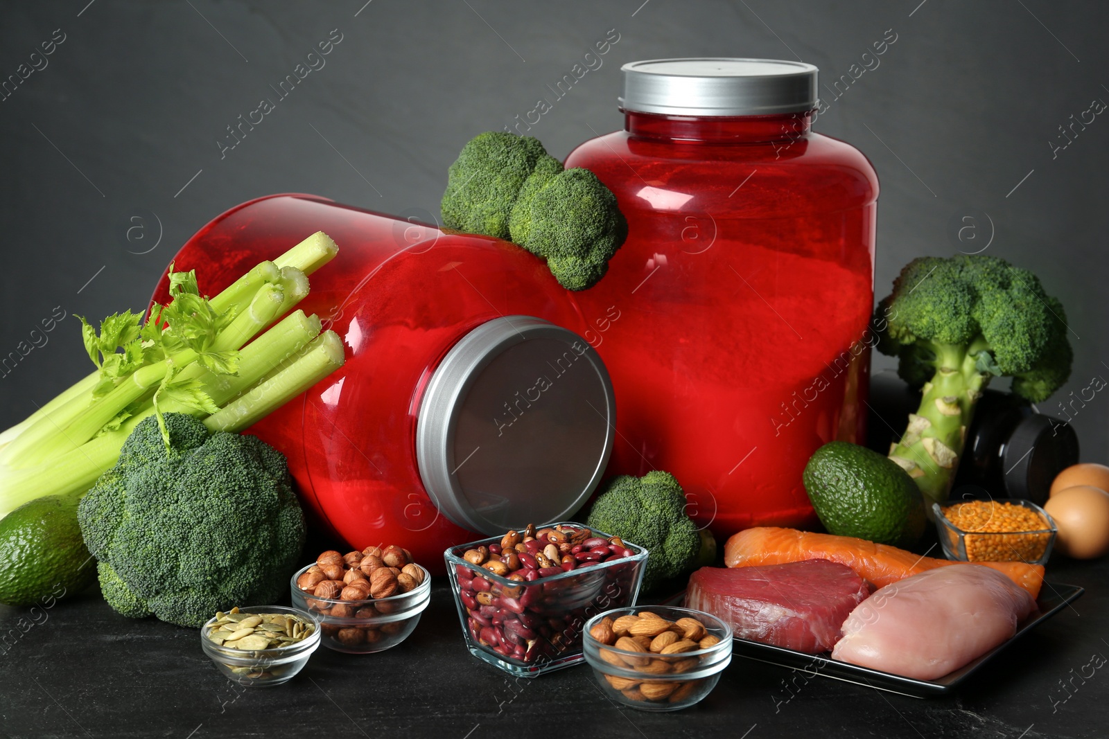 Photo of Set of products rich in amino acids and supplements on black table