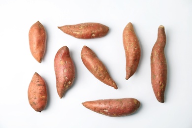 Photo of Composition with sweet potatoes on white background, top view