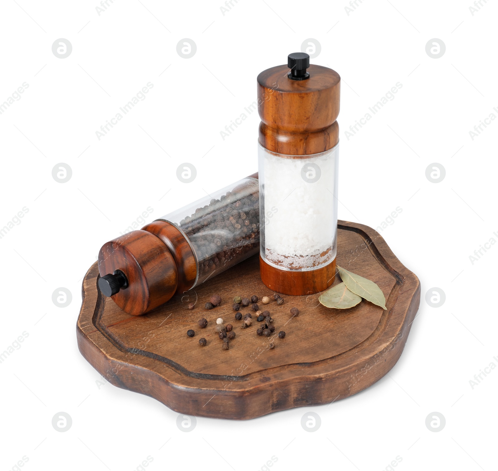 Photo of Salt and pepper shakers with bay leaves isolated on white