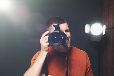 Image of Professional photographer taking picture in modern studio