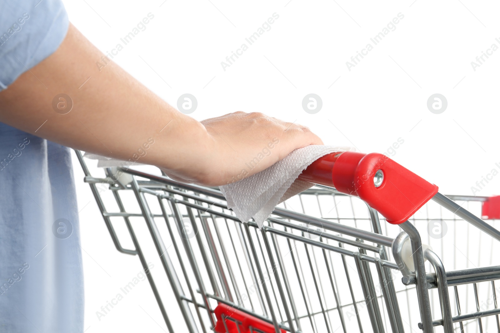 Photo of Woman holding shopping cart handle with tissue paper on white background, closeup