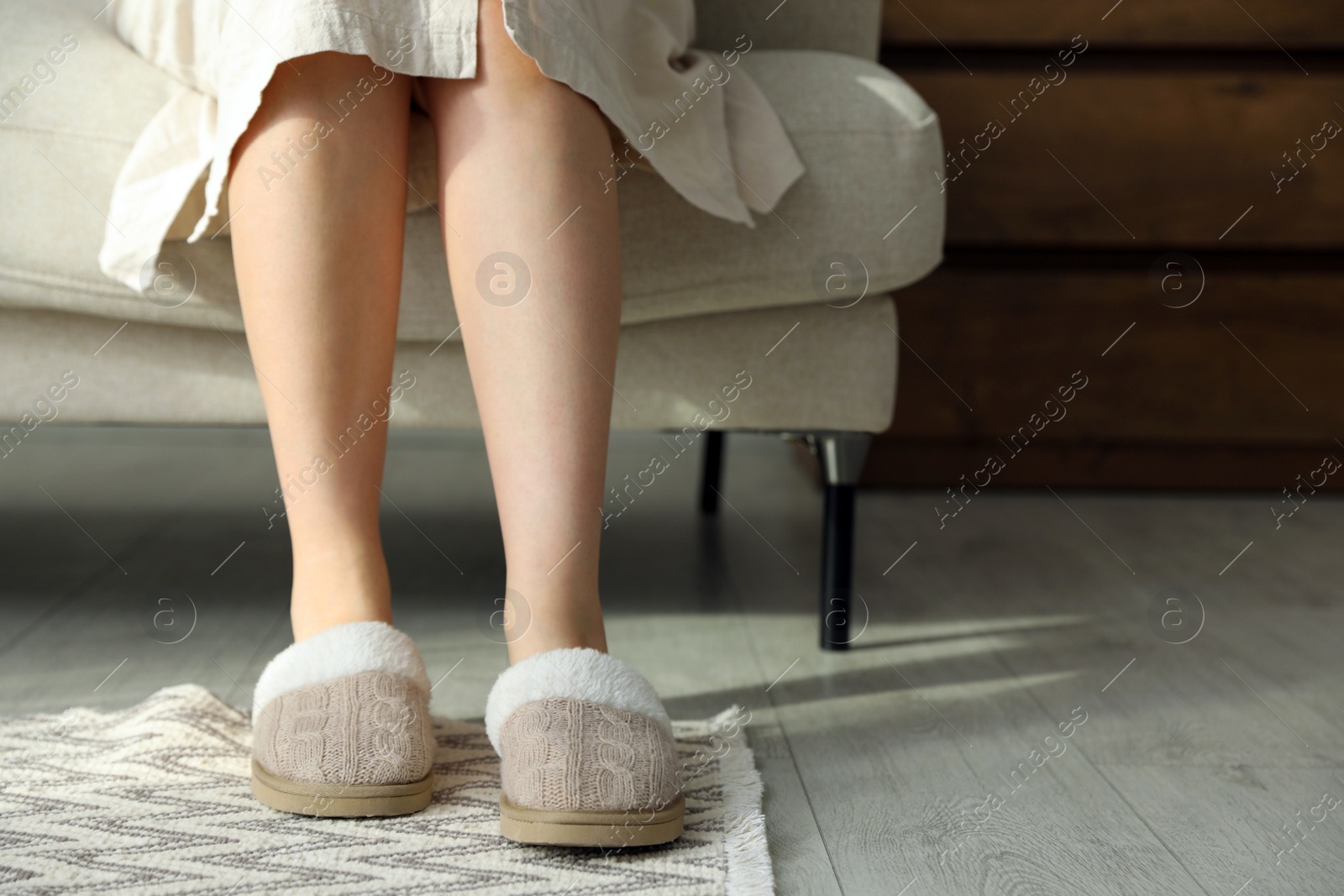 Photo of Woman in soft slippers at home, closeup