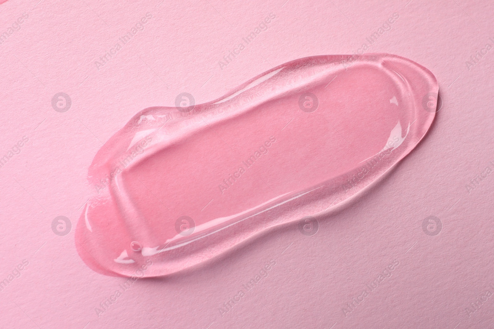 Photo of Swatch of cosmetic gel on pink background, top view