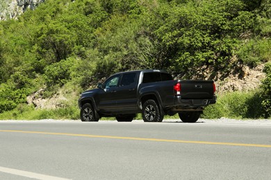 Picturesque view of black car on mountain road