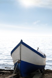 Moored boat on beach near sea outdoors