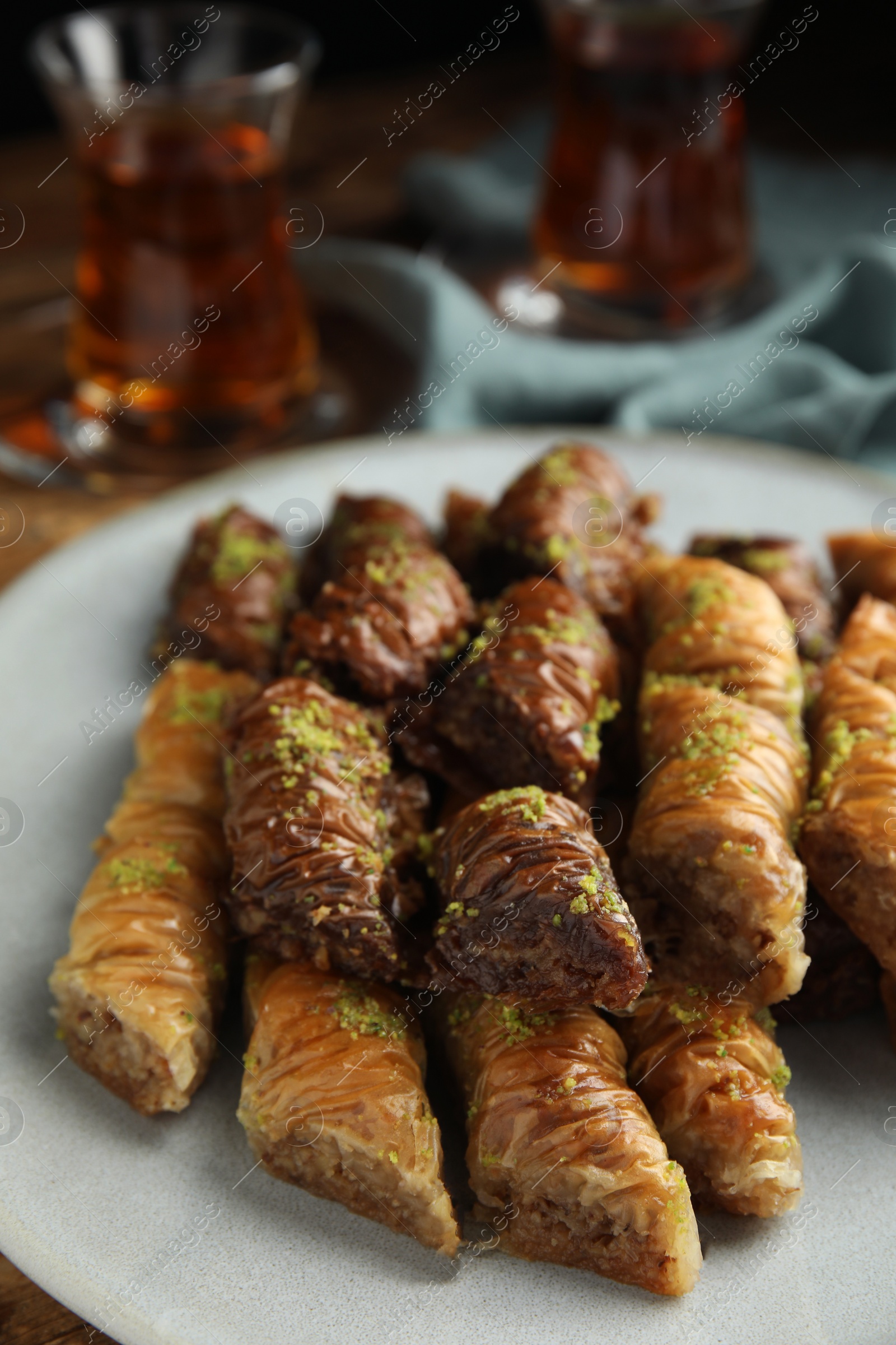 Photo of Delicious baklava with pistachios on plate, closeup