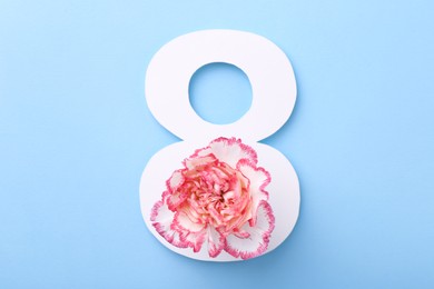 Photo of Paper number 8 and beautiful flower on light blue background, top view