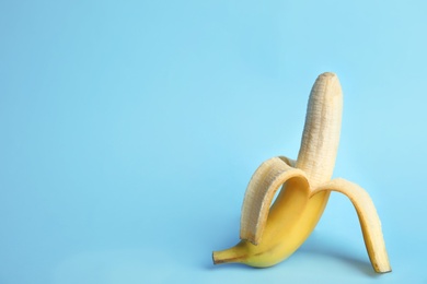 Fresh banana on light blue background, space for text. Sex concept