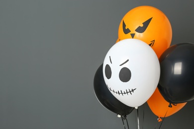 Color balloons for Halloween party on gray background. Space for text