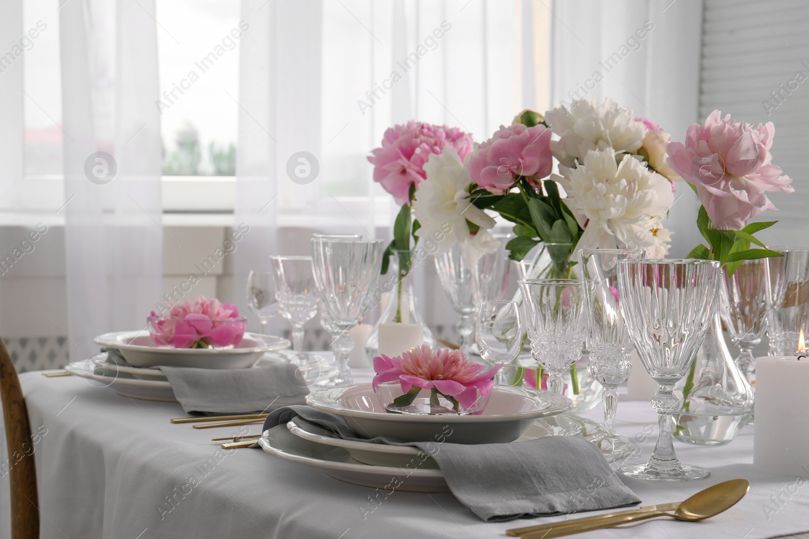 Photo of Stylish table setting with beautiful peonies in dining room