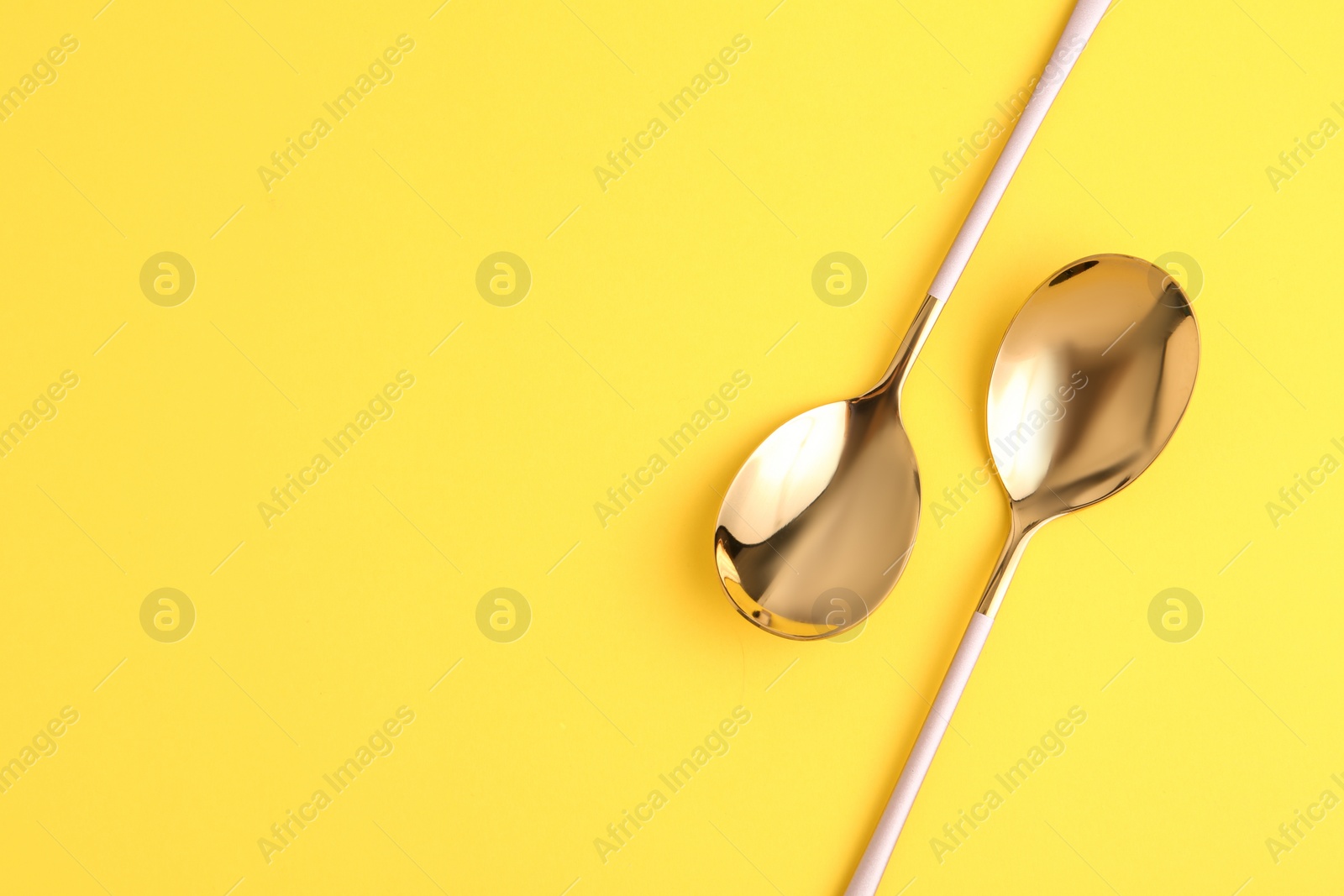 Photo of Clean tablespoons and space for text on color background, flat lay