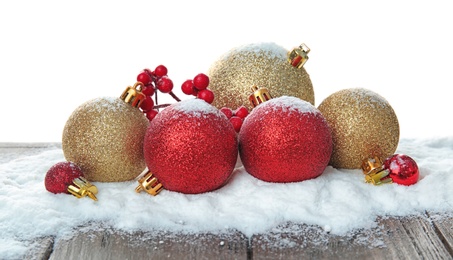 Photo of Christmas decoration and snow on table against white background