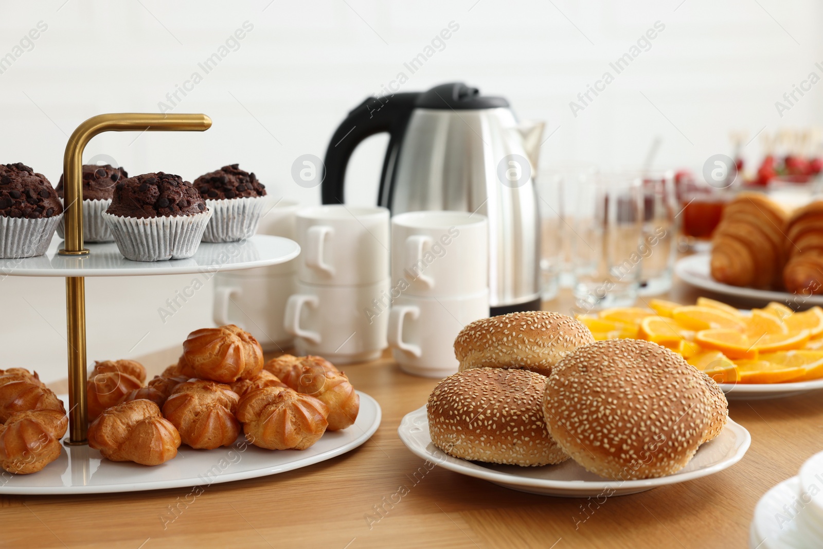 Photo of Different meals served on wooden table indoors, closeup. Buffet menu