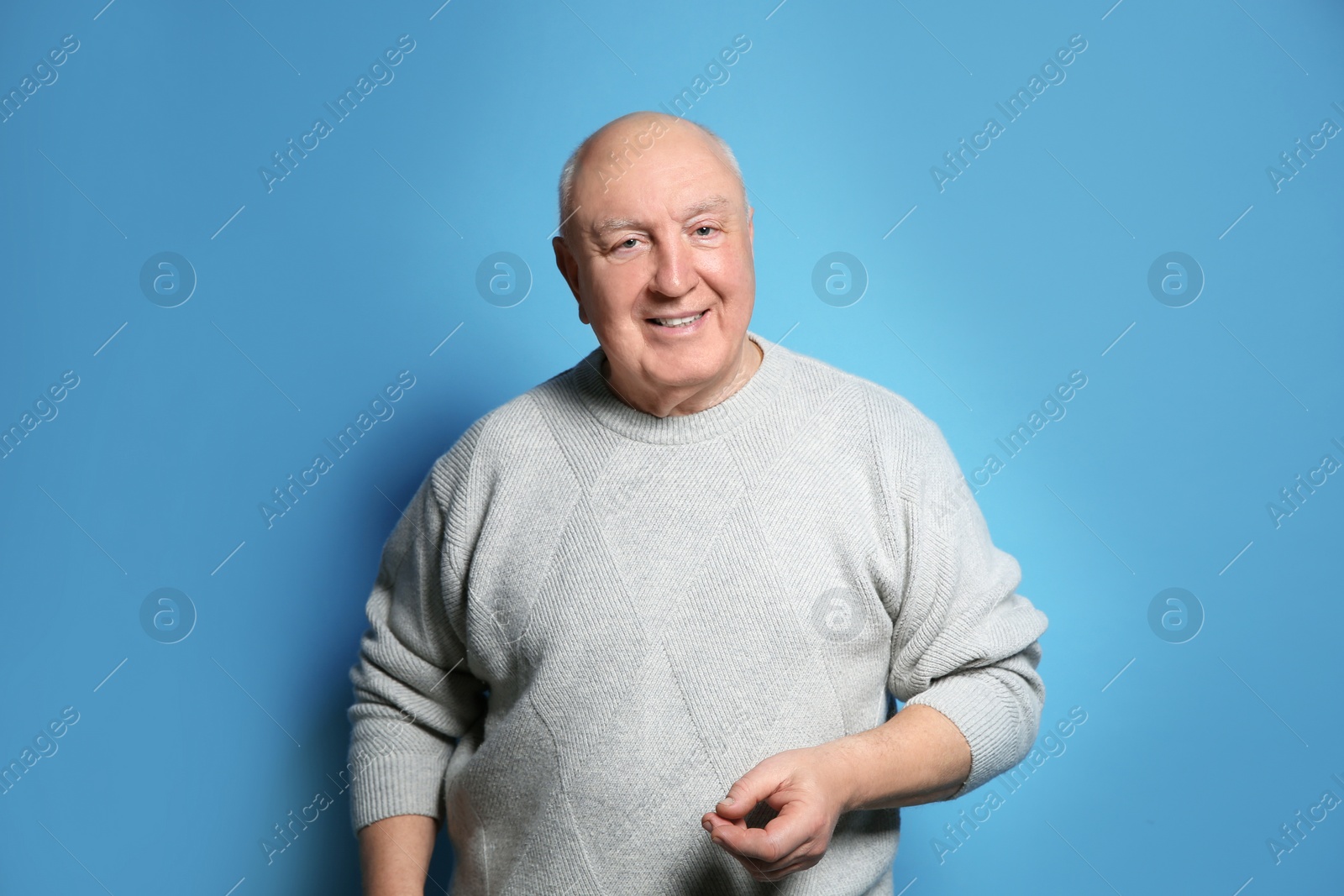 Photo of Portrait of elderly man on color background