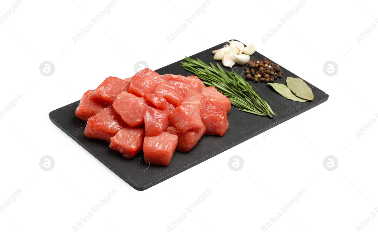 Photo of Pieces of raw beef, bay leaves, garlic, rosemary and peppercorns isolated on white