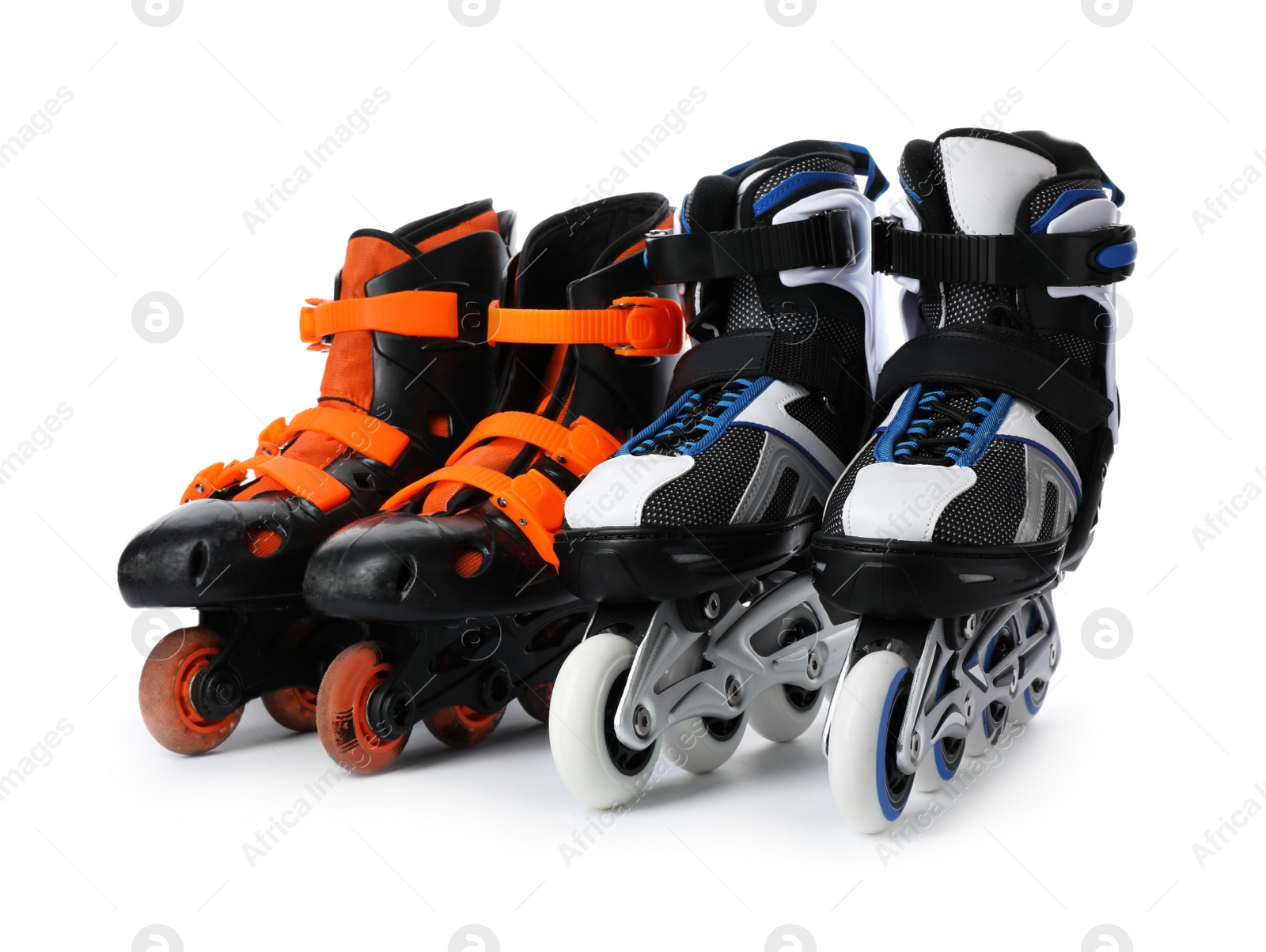 Photo of Pairs of inline roller skates on white background