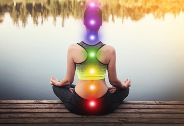 Image of Woman meditating on wooden pier near river, back view. Scheme of seven chakras, illustration