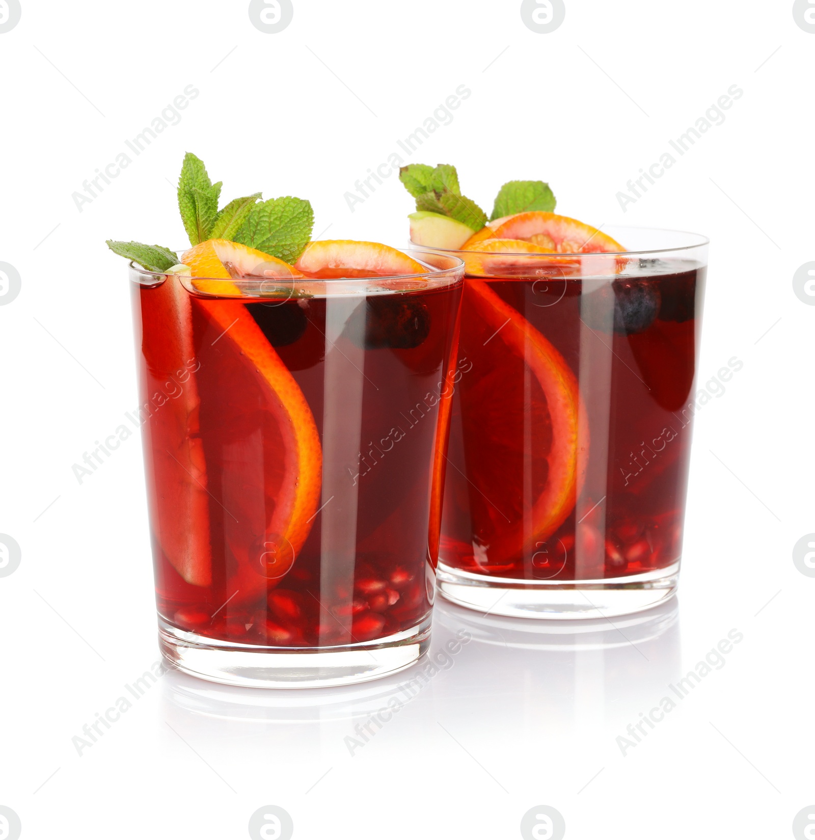 Photo of Aromatic Sangria drink in glasses isolated on white