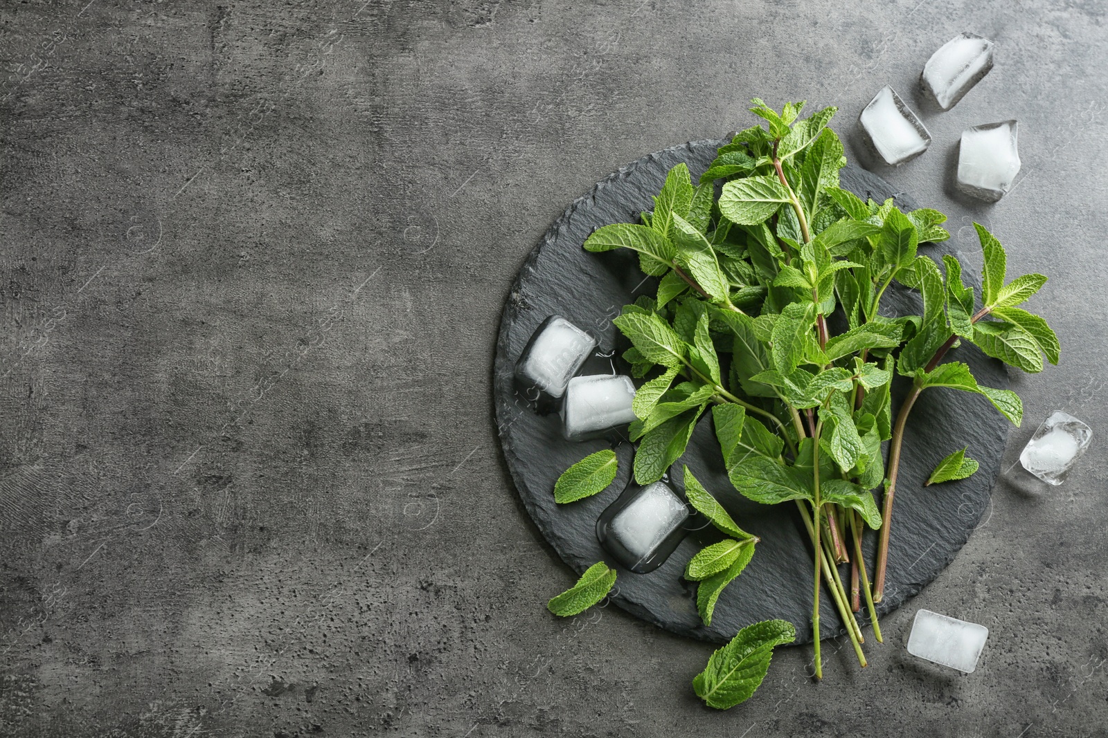 Photo of Flat lay composition with mint and ice cubes on grey background