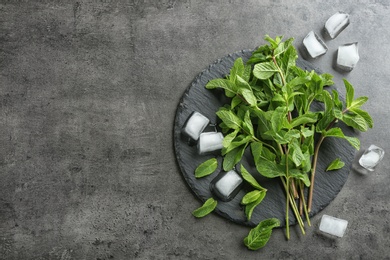 Flat lay composition with mint and ice cubes on grey background