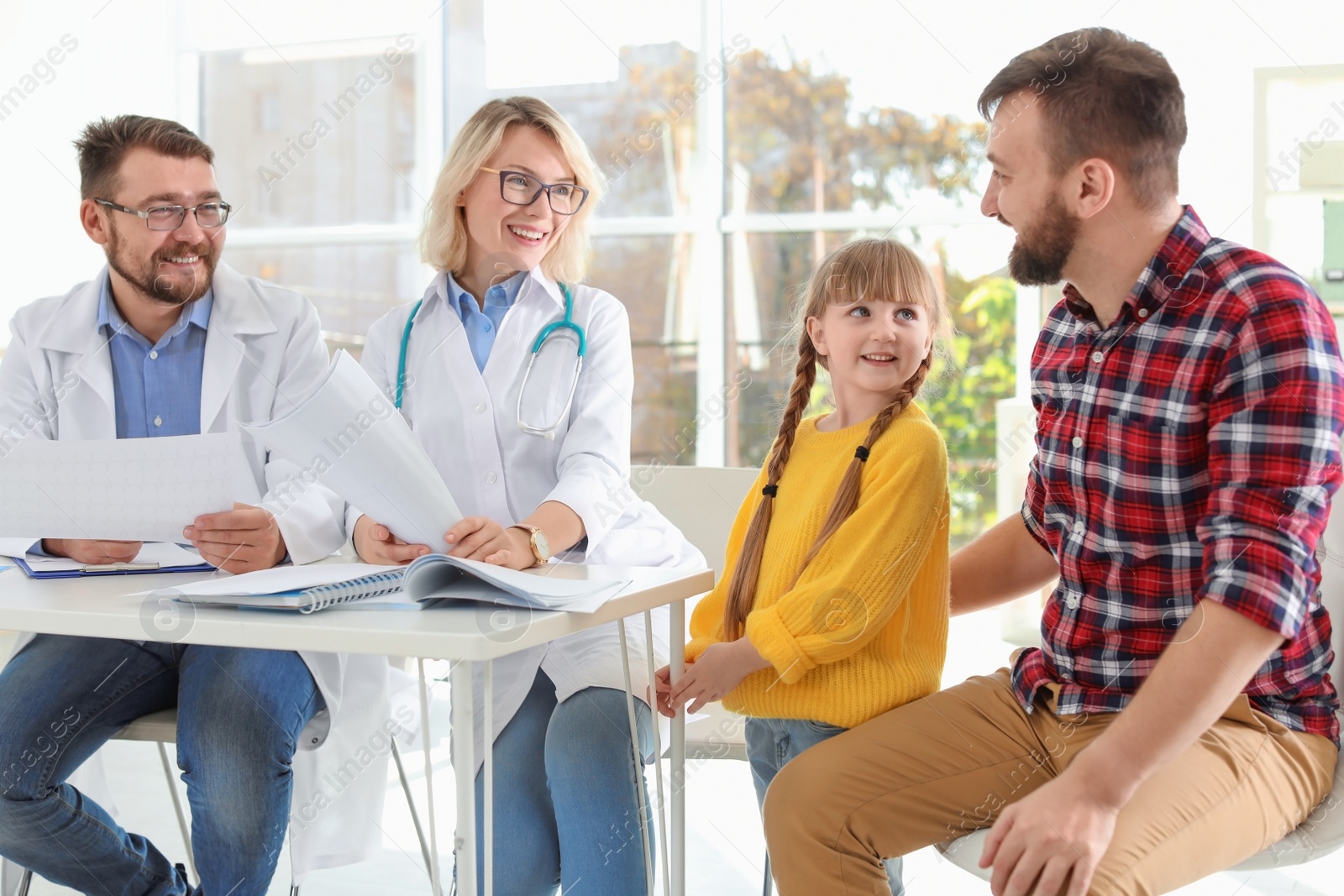 Photo of Little girl with father visiting children's doctors in hospital