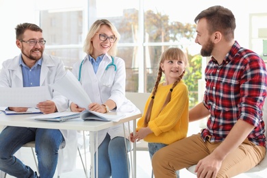 Photo of Little girl with father visiting children's doctors in hospital