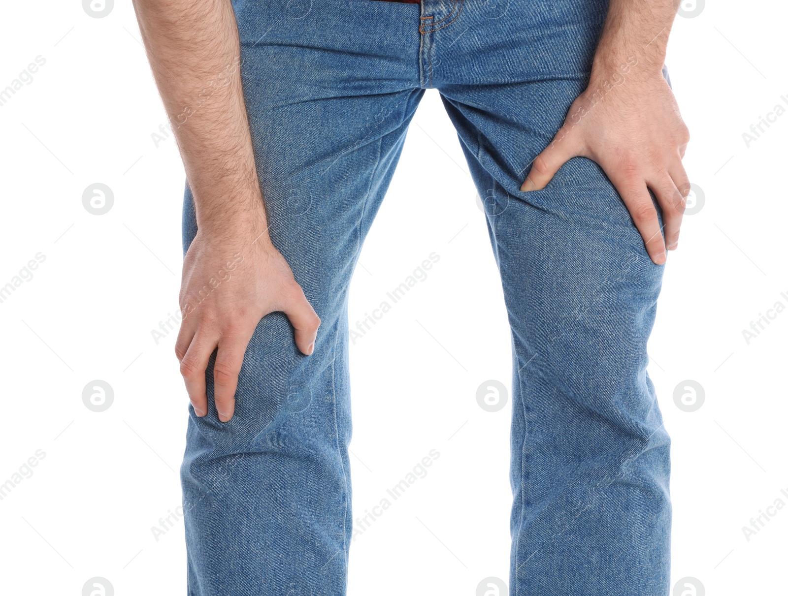 Photo of Young man suffering from leg pain on white background, closeup