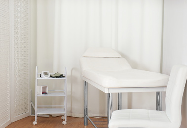 Empty examination couch in modern medical office