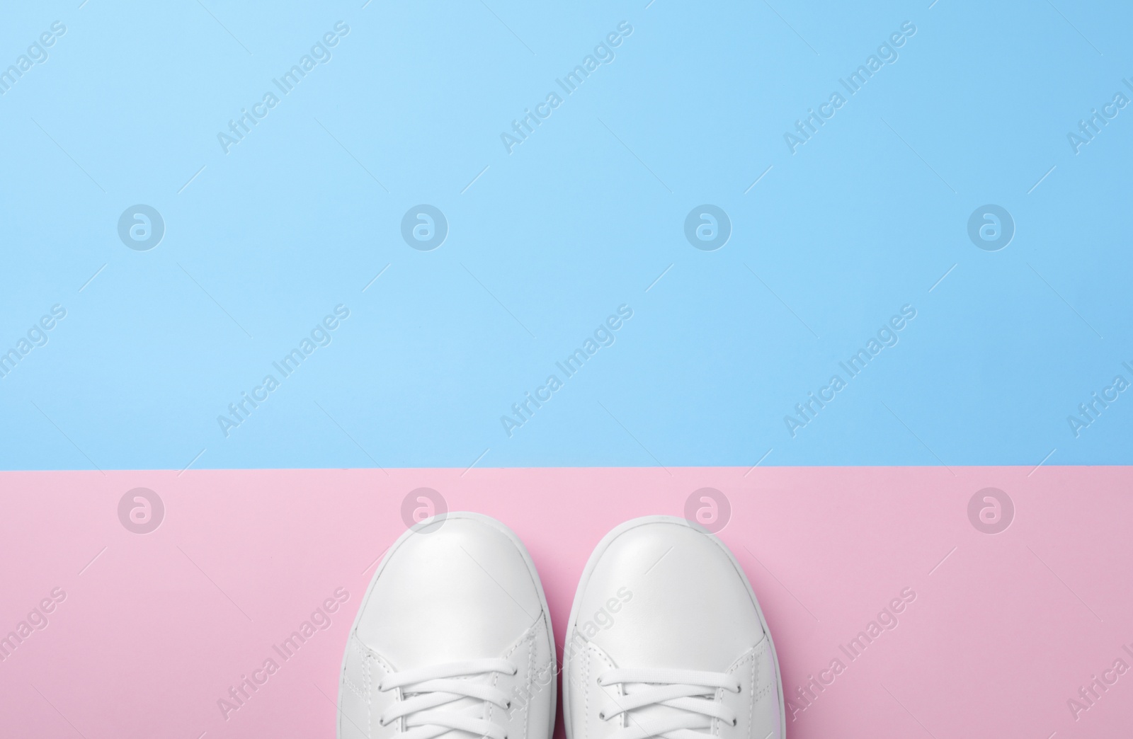 Photo of Pair of sneakers on color background, flat lay. Space for text