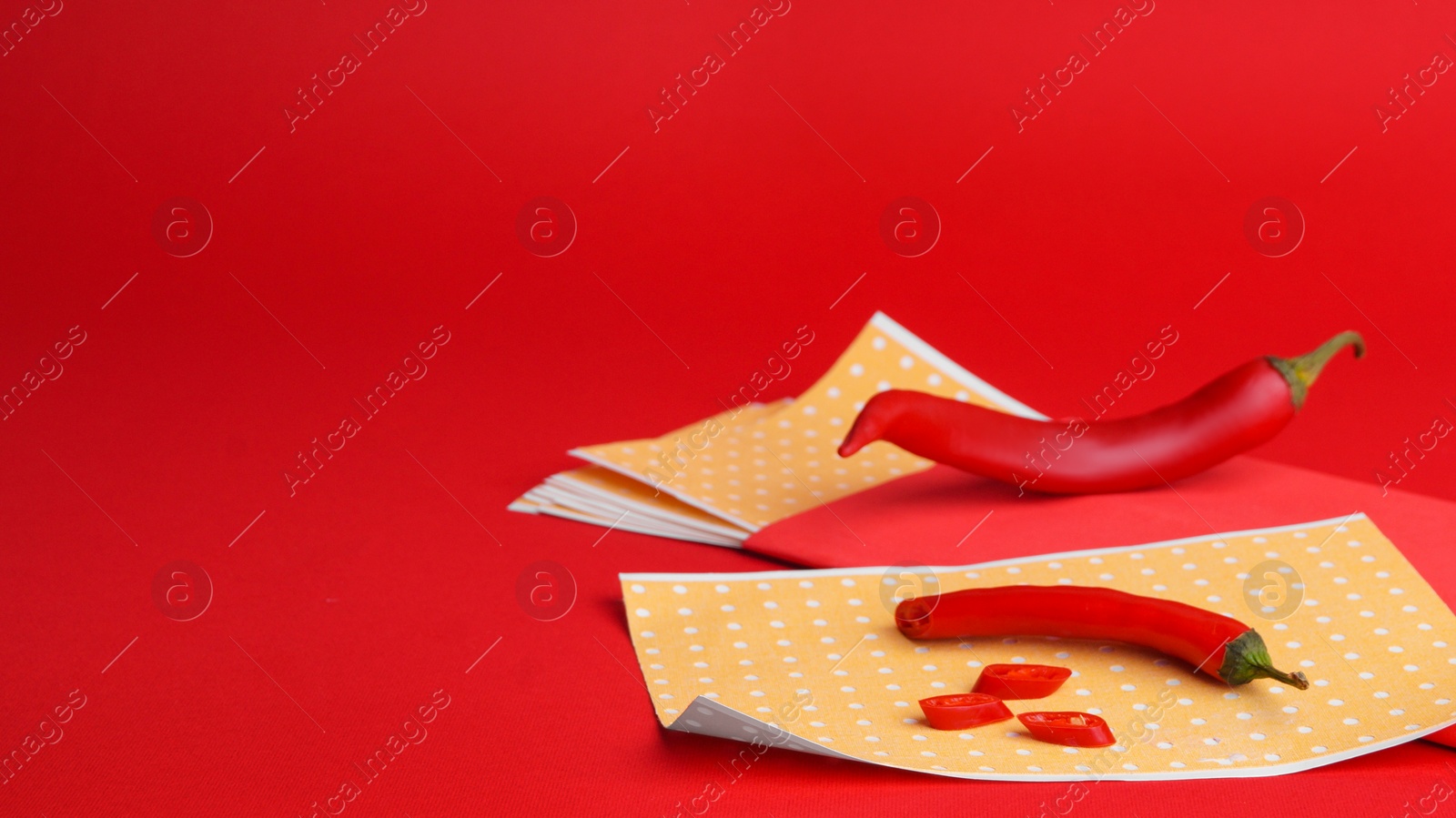 Photo of Pepper plasters and chili on red background, space for text. Alternative medicine